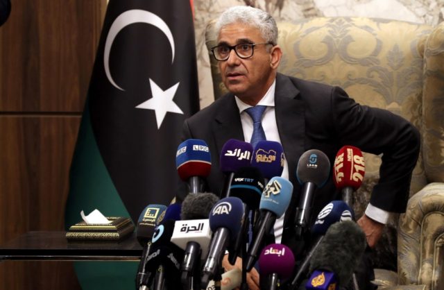 Libyan interim Prime Minister Fathi Bashagha, newly named by the Libyan parliament, delivers a speech at Mitiga International Airport in Tripoli on February 10, 2022. (AFP)