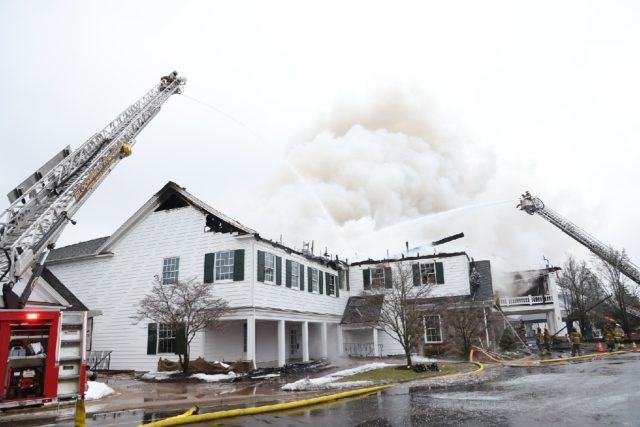 Firefighters battle a massive fire on Thursday at the century-old clubhouse of Oakland Hil