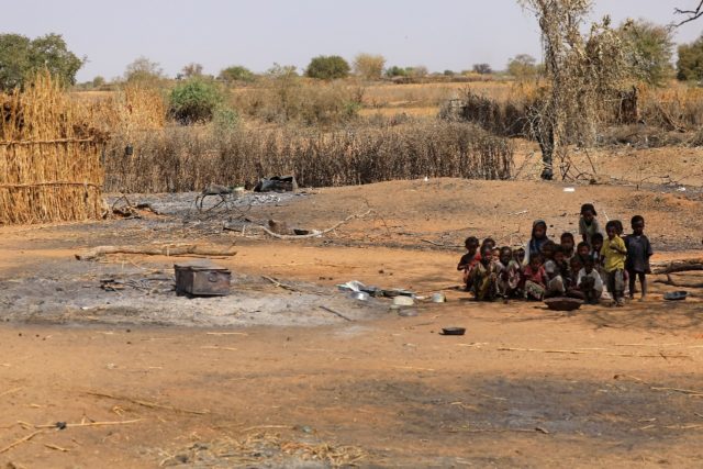 Sudanese children sit together on February 2, 2021 following violence in the Darfuri villa