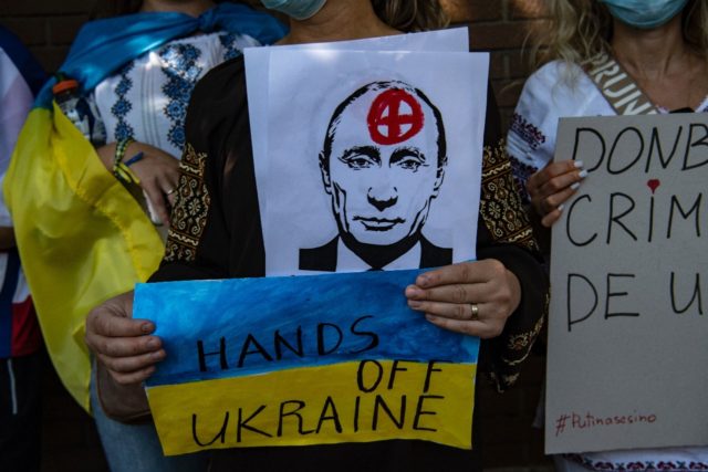 Ukrainian citizens take part in a protest in support of Ukraine in front of the Russian Em