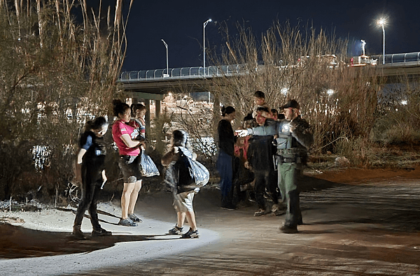 Border Patrol agents, a Texas DPS CID Agent, and Texas National Guard process a group of migrants from )Venezuela, Honduras, and Guatemala. (Bob Price/Breitbart Texas