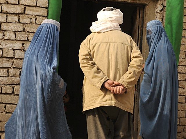 Afghans walk through Kabul on January 14, 2010. The number of civilians killed in the Afgh