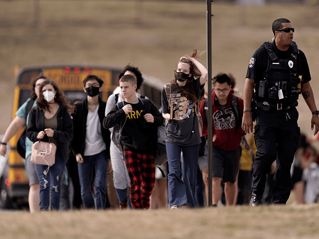 Students from Olathe East High School are lead to a staging area to reunite with their parents after a shooting at the school Friday, March 4, 2022, in Olathe, Kan. Authorities say a suspect shot and wounded a school resource officer and an administrator at the suburban Kansas City high …