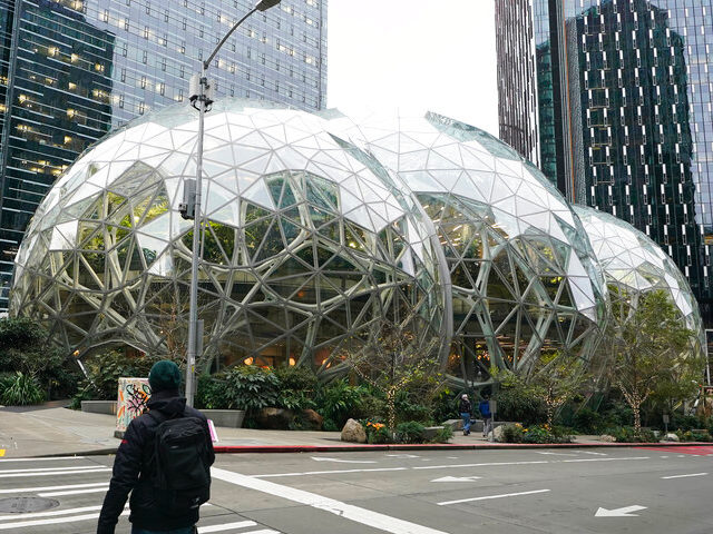 A pedestrian walks near the Amazon Spheres on the company's corporate campus in downtown S