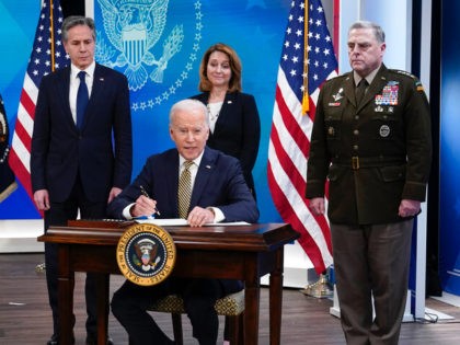 President Joe Biden signs a delegation of authority in the South Court Auditorium on the White House campus in Washington, Wednesday, March 16, 2022. From left, Secretary of State Antony Blinken, Biden, Deputy Secretary of Defense Kathleen Hicks and Chairman of the Joint Chiefs of Staff General Mark Milley. (AP …