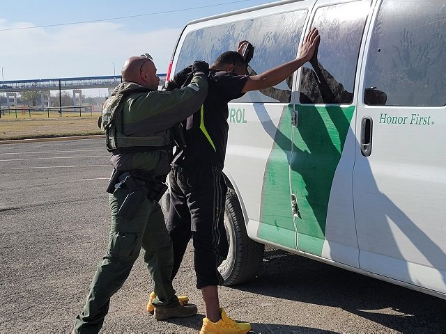 A Border Patrol agents in Eagle Pass, Texas, arrests a migrant after he illegally crossed the border from Mexico. (File Photo: Bob Price/Breitbart Texas)