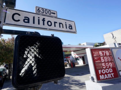 A California street sign is shown next to the price board at a gas station in San Francisc