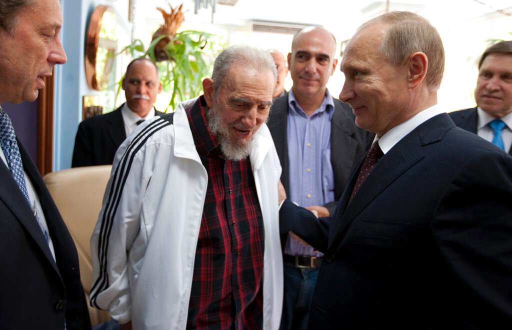 In this July 11, 2014 file photo, Cuba's Fidel Castro, center, visits with Russia's President Vladimir Putin, right, in Havana, Cuba. (AP Photo/Alex Castro, File)