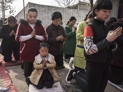 SHIJIAZHUANG, CHINA - APRIL 09: (CHINA OUT) Chinese Catholic worshippers kneel and pray during Palm Sunday Mass during the Easter Holy Week at an "underground" or "unofficial" church on April 9, 2017 near Shijiazhuang, Hebei Province, China. China, an officially atheist country, places a number of restrictions on Christians, allowing …