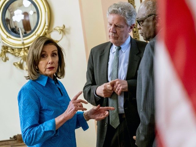House Speaker Nancy Pelosi of Calif., left, speaks with House Majority Whip James Clyburn, of S.C., right, and Rep. Frank Pallone, D-N.J., center, after signing H.R. 3076, the Postal Service Reform Act during a ceremony on Capitol Hill in Washington, Thursday, March 17, 2022.