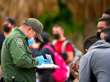 Border Patrol agents process a group of migrants apprehended in March in the Del Rio Secto
