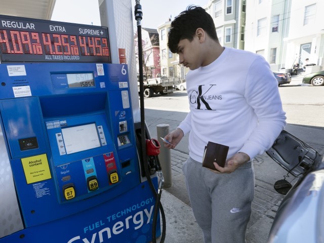 Jason Ventura prepares to pump gas into his vehicle, Friday, March 4, 2022, in Boston.