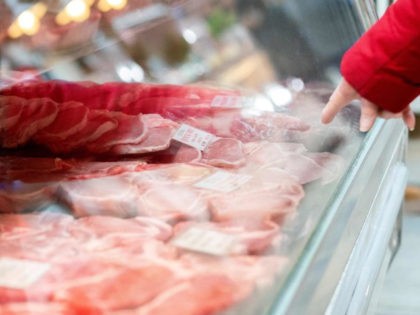 A customer points out what cut of meat they want at Union Meat Company in Eastern Market in Washington, DC, on February 8, 2022. - In the United States, land of barbecues and steakhouses, beef is becoming a luxury. Overall consumer prices rose by seven percent over the course of …