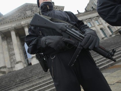 BERLIN - NOVEMBER 23: German police armed with submachine guns patrol next to the Reichstag, seat of the Bundestag, or German parliament, on the day Bundestag members began debates over the 2011 German federal budget on November 23, 2010 in Berlin, Germany. Heavily-armed police checked vehicles arriving at the Reichstag …