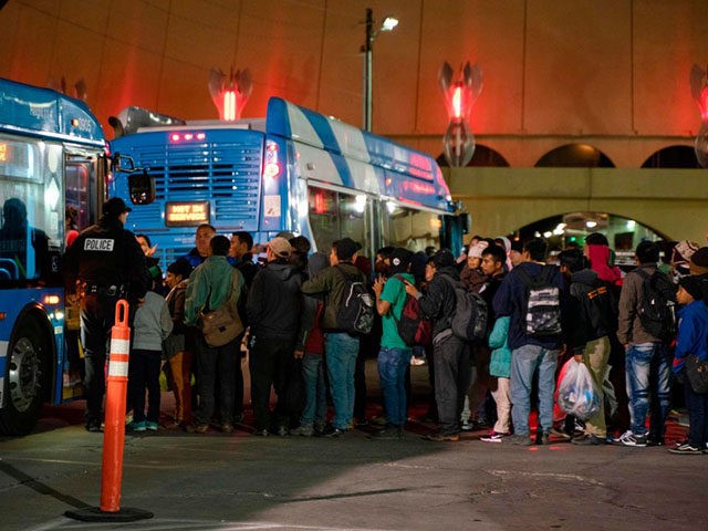 Asylum seekers board a bus stop after they were dropped off by Immigration and Customs Enforcement (ICE) officials earlier at the Greyhound bus station in downtown El Paso, Texas late on December 23, 2018. - The group of around 200, mostly made up of Central Americans, were left without money, …