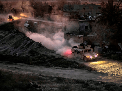 A general view shows a vehicle of the Kurdish-led Syrian Democratic Forces (SDF) in the village of Baghouz, near Syria's border with Iraq, in the eastern Deir Ezzor province on March 11, 2019, as their battle continues against the last pocket of Islamic State group (IS) jihadists. - Baghouz is …