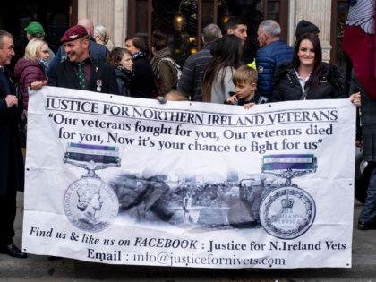 Sympathisers hold a banner in support of motorcyclists riding in a protest against the Bloody Sunday prosecution of Soldier F and in support of all Veterans, in central London on April 12, 2019. - A former British soldier faces murder charges of two people after troops opened fire on civil …