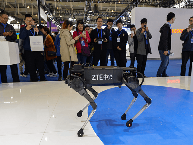 Visitors look at a robotic dog by ZTE during the 2019 World Intelligent Manufacturing Conf
