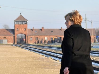 TOPSHOT - German Chancellor Angela Merkel walks in front of the main railway entrance to Birkenau as she visits the former German Nazi death camp Auschwitz-Birkenau in Oswiecim, Poland on December 6, 2019. - Merkel is on her first visit to the Auschwitz former German death camp, the site symbolising …