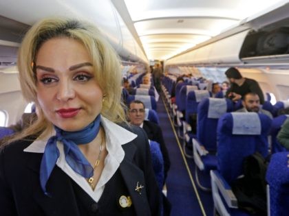A stewardess walks by aboard the first flight from the Syrian capital Damascus to Aleppo's airport on February 19, 2020, since the war forced its closure in 2012. - A civilian airliner landed at Aleppo airport marking the relaunch of commercial flights to the war-torn northern city after more than …