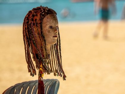A mannequin head being used to advertise a hair dreadlock and weaving service is pictured on a quiet beach in Pattaya on March 7, 2020, as visitor numbers in the region have plunged due to the outbreak of the COVID-19 coronavirus. (Photo by Mladen ANTONOV / AFP) (Photo by MLADEN …
