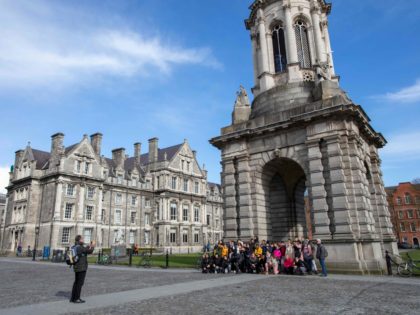 A group have their photograph taken at Trinity College Dublin on March 12, 2020. - Ireland on Thursday announced the closure of all schools and colleges, and recommended the cancellation of mass gatherings as part of measures to combat the spread of the coronavirus. Prime Minister Leo Varadkar said "schools, …