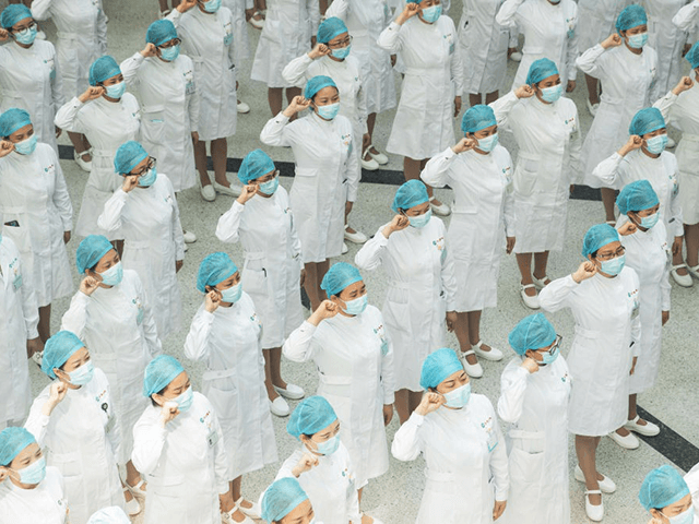 Nurses recite an oath during a ceremony marking International Nurses Day, at Tongji Hospit