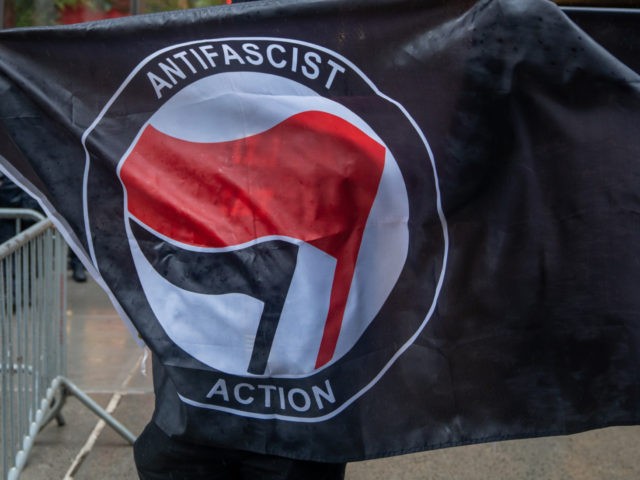 NEW YORK, NY - APRIL 11: People hold Antifa flags at Trump Tower to counter protest the &q
