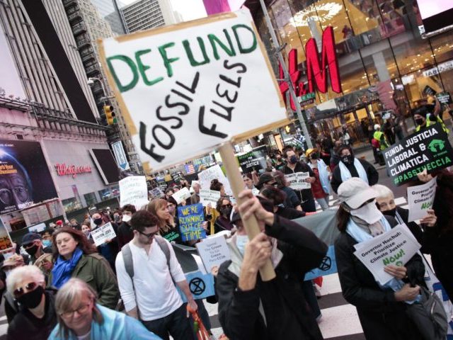 People attend the Climate Justice March as they protest from Times Square to Governor Hochul's Manhattan office in New York on November 13, 2021. - UN chief Antonio Guterres said the world was still on the precipice of "catastrophe" after nations reached a global climate deal Saturday that fell short …