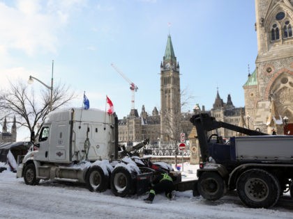 A protester's truck is towed away after police cleared the street of demonstrators in Ottawa, Ontario, Canada, on February 19, 2022. - Police pushed into downtown Ottawa Saturday in a bid to dislodge several hundred dug-in protesters and big rigs that have choked the Canadian capital for weeks, after a …
