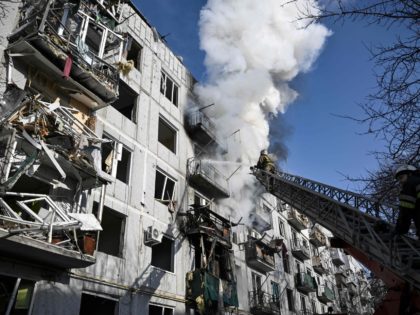 TOPSHOT - Firefighters work on a fire on a building after bombings on the eastern Ukraine town of Chuguiv on February 24, 2022, as Russian armed forces are trying to invade Ukraine from several directions, using rocket systems and helicopters to attack Ukrainian position in the south, the border guard …