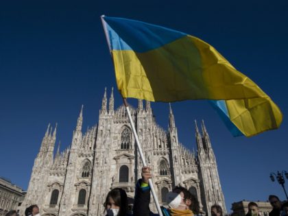 A person waves the Ukrainian flag during a demonstration against Russia's invasion of Ukraine, in the northern city of Milan, on February 26, 2022. - Pro-Ukraine protests erupted across the world on February 26, 2022, as thousands took to the streets from London to Rome to Barcelona to denounce Russia's …