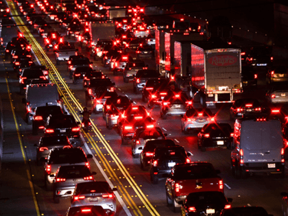 A motorcyclist drives between cars, trucks, and sport utility vehicles (SUVs) on the 405 Freeway during rush hour traffic as oil and gasoline fuel prices experienced an increase on March 10, 2022 in Los Angeles, California. - US consumer prices hit a new 40-year high last month as the world's …