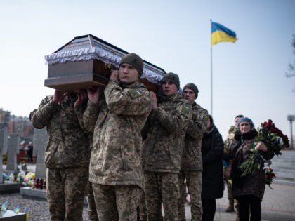 LVIV, UKRAINE - MARCH 15: Ukrainian servicemen carry a coffin during the funeral service for Oleh Yaschyshyn, Sergiy Melnyk, Rostyslav Romanchuk and Kyrylo Vyshyvany in Lychakivske cemetery on March 15, 2022 in Lviv, Ukraine. The men died in Sunday's airstrike on the nearby International Center for Peacekeeping and Security at …