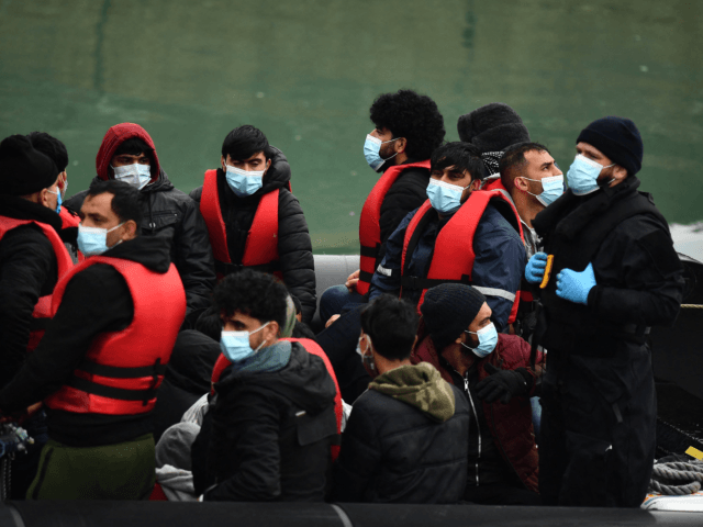 Migrants are seen on the UK Border Force vessel HMC Alert, after they were picked up at sea while attempting to cross the English Channel, and brought to the Marina in Dover, southeast England, on March 16, 2022. - The high number of migrants crossing to Britain from mainland Europe …