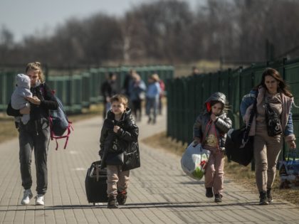 TOPSHOT - Refugees from Ukraine cross the border at the border crossing in Medyka, southeastern Poland, on March 24, 2022, following Russia's invasion of Ukraine. - More than 3.6 million people have fled Ukraine since the Russian invasion began, according to the UN. (Photo by Angelos Tzortzinis / AFP) (Photo …