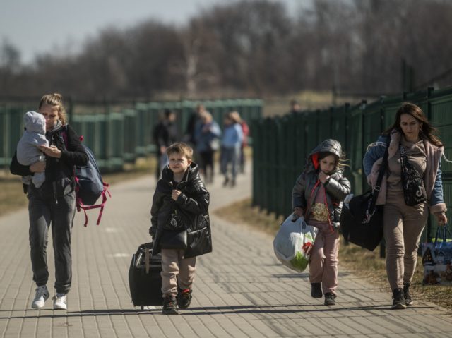TOPSHOT - Refugees from Ukraine cross the border at the border crossing in Medyka, southea