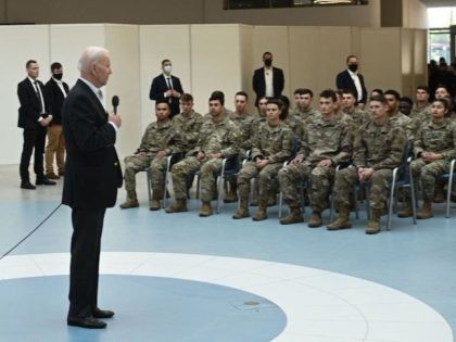 US President Joe Biden (C) talks to service members from the 82nd Airborne Division, who a