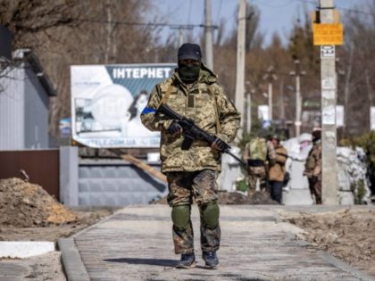 A volunteer patrols at a checkpoint in Stoyanka, on March 27, 2022, amid Russian invasion of Ukraine.