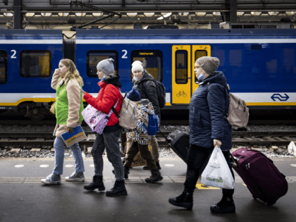 Ukrainian refugees are helped by volunteers upon their arrival at Amsterdam Central statio