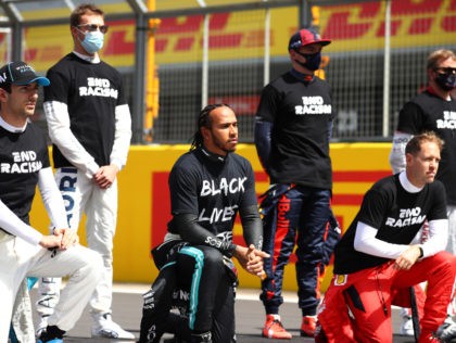 NORTHAMPTON, ENGLAND - AUGUST 02: Lewis Hamilton of Great Britain and Mercedes GP takes a knee on the grid in support of the Black Lives Matter movement prior to the F1 Grand Prix of Great Britain at Silverstone on August 02, 2020 in Northampton, England. (Photo by Bryn Lennon/Getty Images)