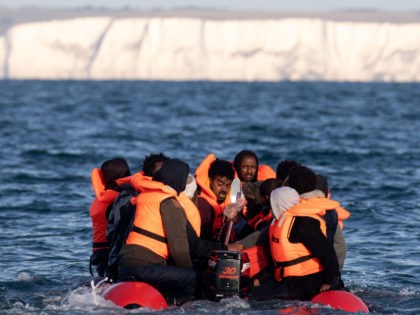 AT SEA, UNITED KINGDOM - SEPTEMBER 07: Migrants packed tightly onto a small inflatable boa