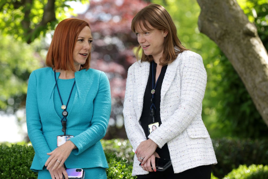 WASHINGTON, DC - MAY 13: White House Press Secretary Jen Psaki (L) and White House Communications Director Kate Bedingfield (R) wait for President Joe Biden to deliver remarks on the COVID-19 response and vaccination program in the Rose Garden of the White House on May 13, 2021 in Washington, DC. The Centers for Disease Control and Prevention (CDC) announced today that fully vaccinated people will no longer need to wear masks or socially distance for indoor and outdoor activities in most settings. (Photo by Alex Wong/Getty Images)
