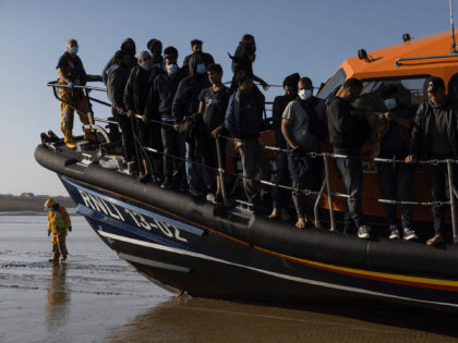 DUNGENESS, ENGLAND - SEPTEMBER 07: A group of migrants arrive via the RNLI (Royal National Lifeboat Institution) on Dungeness beach on September 7, 2021 in Dungeness, England. The week has seen a major increase in migrant numbers due to fair weather. (Photo by Dan Kitwood/Getty Images)