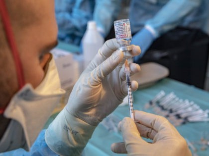 BOLZANO, ITALY - DECEMBER 11: Nurses prepare and check vaccine syringes at FieraMesse, the