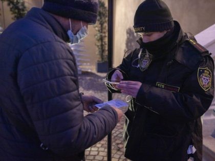 BOLZANO, ITALY - DECEMBER 12: A man has his Green Pass cheked before entering a restaurant