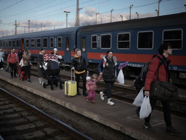 ZAHONY, HUNGARY - MARCH 08: Refugees fleeing Ukraine arrive at the border train station of