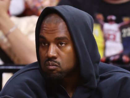 Rapper Kanye West looks on courtside during the first half between the Miami Heat and the