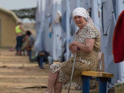 A refugee from eastern Ukraine looks on as she sits in a refugee camp near the Russian city of Donets'k, Rostov region, about 15 kilometers from the Russian-Ukrainian border. Some 285,000 people have already fled their homes due to the conflict in east Ukraine, it is estimated, with many leaving …