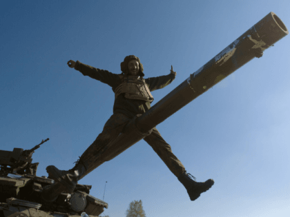 A Ukrainian serviceman gestures as he sits on a tank barrel in a basecamp near the town of Debaltseve in the Donetsk region, on October 6, 2014. The first European drones landed in Ukraine and a top US envoy visited Kiev in an urgent bid to bolster its crumbling truce …